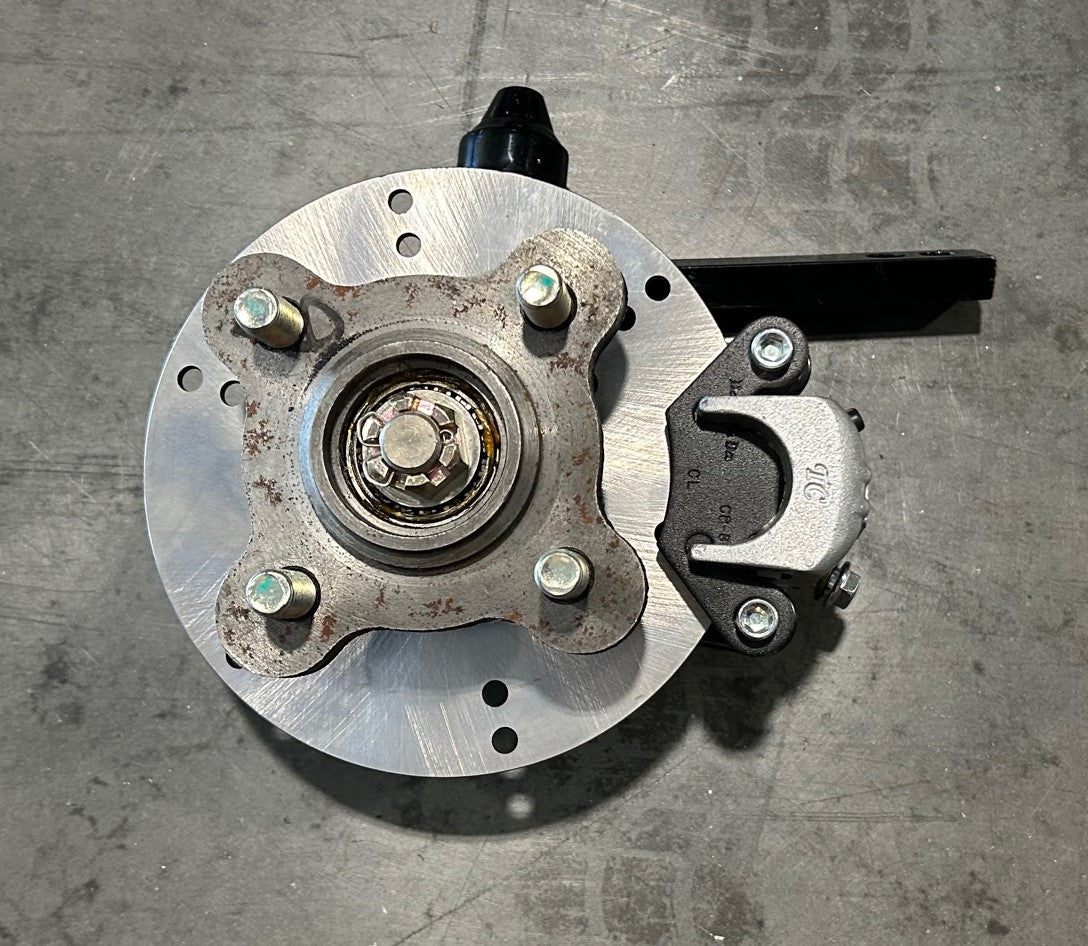 SPINDLE, FRONT DRIVERS SIDE, PEAK/ ANTHEM, WITH BRAKES AND HUB (OLD STYLE)